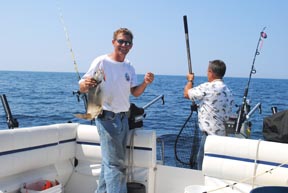 captain brian helminen of sand point charters holding fish